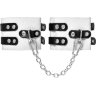 Бело-черные оковы с двумя ремешками и люверсами
