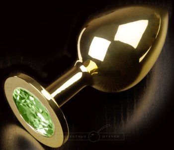 Золотистая анальная пробка с салатовым кристаллом - 9 см.